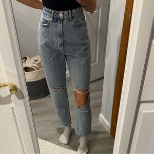 Loose mom jeans with distressed knees